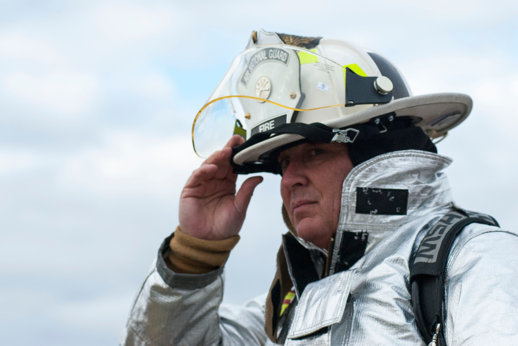 Firefighter Timothy Burris with Arizona Air National Guard’s 162nd Wing gears up to set fire to a mock aircraft during a joint live fire training with firefighters from Davis-Monthan Air Force Base and the Tucson International Airport on Dec. 8 at D-M AFB. The fire team lit a total of five fires to meet the group’s annual training requirements. (U.S. Air National Guard photo by 2nd Lt. Lacey Roberts)