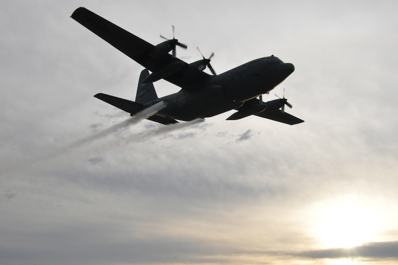 A modified U.S. C-130 aircraft, assigned to the 910th Airlift Wing, sprays water simulating a pesticide solution during a field exercise as part of the Department of Defense Aerial Spray Certification Course at the Lee County Mosquito Control District flightline here, Jan. 13, 2016. According to the 910th’s entomologists, the purpose of the exercise was to determine how wide of an area on the ground is being effectively treated by an aerial spray aircraft and how effectively the sprayed product is being delivered to the target area. Youngstown Air Reserve Station's 910th Airlift Wing is home to DoD’s only aerial spray mission. (U.S. Air Force photo/Master Sgt. Bob Barko Jr.)