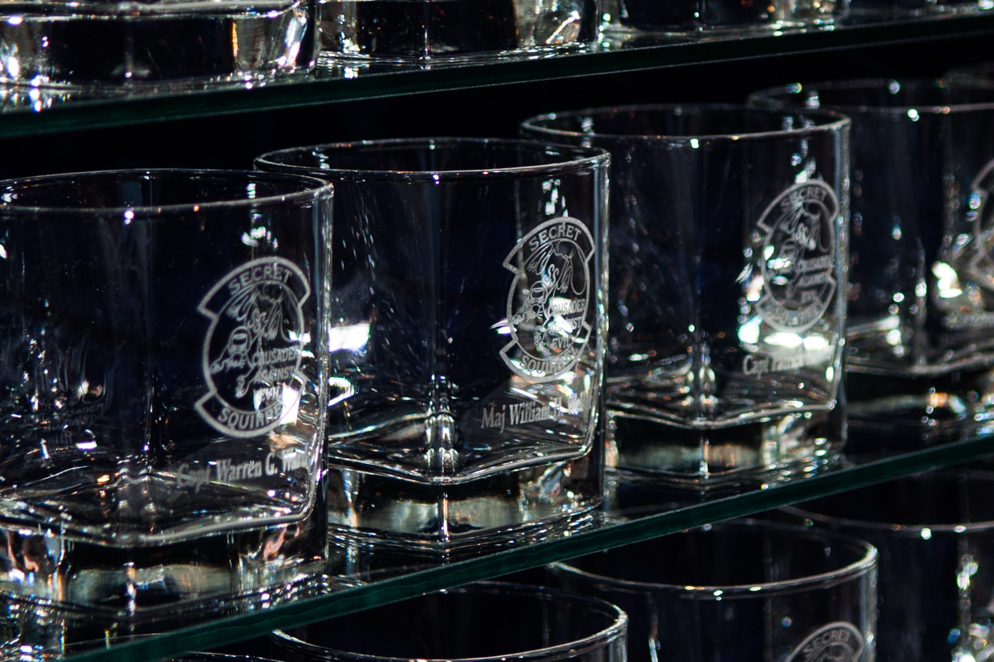 Glasses line a shelf in the Barksdale Global Power Museum on Barksdale Air Force Base, La. on Jan. 15, 2016. Each glass has the name of a U.S. Air Force Airman that flew in Operation Senior Surprise, aka “Secret Squirrel.” On the 25th anniversary of the mission, the museum dedicated an exhibit to the “Secret Squirrel” mission with an inaugural toast to celebrate the mission’s success. This mission kicked off Operation Desert Storm and was the longest combat mission in history at that time, lasting over 35 hours. (U.S. Air Force photo by Master Sgt. Dachelle Melville/Released)