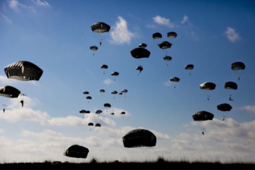 Paratroopers descend to the ground after jumping from an Air Force C-130 aircraft during a proficiency jump program at Pope Army Airfield on Fort Bragg, N.C., Jan. 16, 2016. U.S. Army photo by Spc. Kevin Kim
