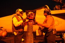 (Dec. 29, 2015) Aviation Ordnanceman 1st Class B. Hall, left, and Aviation Ordnanceman Airman C. Baker, assigned to the "Jolly Rogers" of Strike Fighter Squadron (VFA) 103, upload 20 mm rounds to an F/A-18F Super Hornet on the flight deck of aircraft USS Harry S. Truman (CVN 75). Harry S. Truman Carrier Strike Group is deployed in support of Operation Inherent Resolve, maritime security operations, and theater security cooperation efforts in the U.S. 5th Fleet area of operations. 
