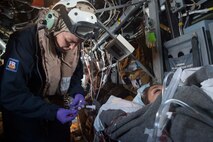 (Dec. 31, 2015) Lt. Kathleen Kostka (left), from Virginia Beach, Virginia, a critical care nurse embarked aboard USS Kearsarge attached to Fleet Surgical Team (FST) 4, simulates sedating a patient during a medical evacuation drill in an MV-22 Osprey. Kearsarge is the flagship for the Kearsarge Amphibious Ready Group (ARG) and, with the embarked 26th Marine Expeditionary Unit (MEU), is deployed in support of maritime security operations and theater security cooperation efforts in the U.S. 5th Fleet area of operation.