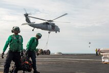 (Jan. 5, 2016) Sailors transport cargo netting on the flight deck of aircraft carrier USS Harry S. Truman (CVN 75) during a replenishment-at-sea. Harry S. Truman Carrier Strike Group is deployed in support of Operation Inherent Resolve, maritime security operations, and theater security cooperation efforts in the U.S. 5th Fleet area of operations.