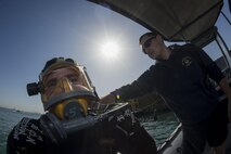 (Jan. 6, 2016) Navy Diver 1st Class Scott Colvin conducts gear checks on Navy Diver 3rd Class Dakota Helm, assigned to Commander, Task Group (CTG) 56.1, prior to conducting an anti-terrorism force protection dive. CTG 56.1 conducts mine countermeasures, explosive ordnance disposal, salvage-diving and force protection operations throughout the U.S. 5th Fleet area of operations.