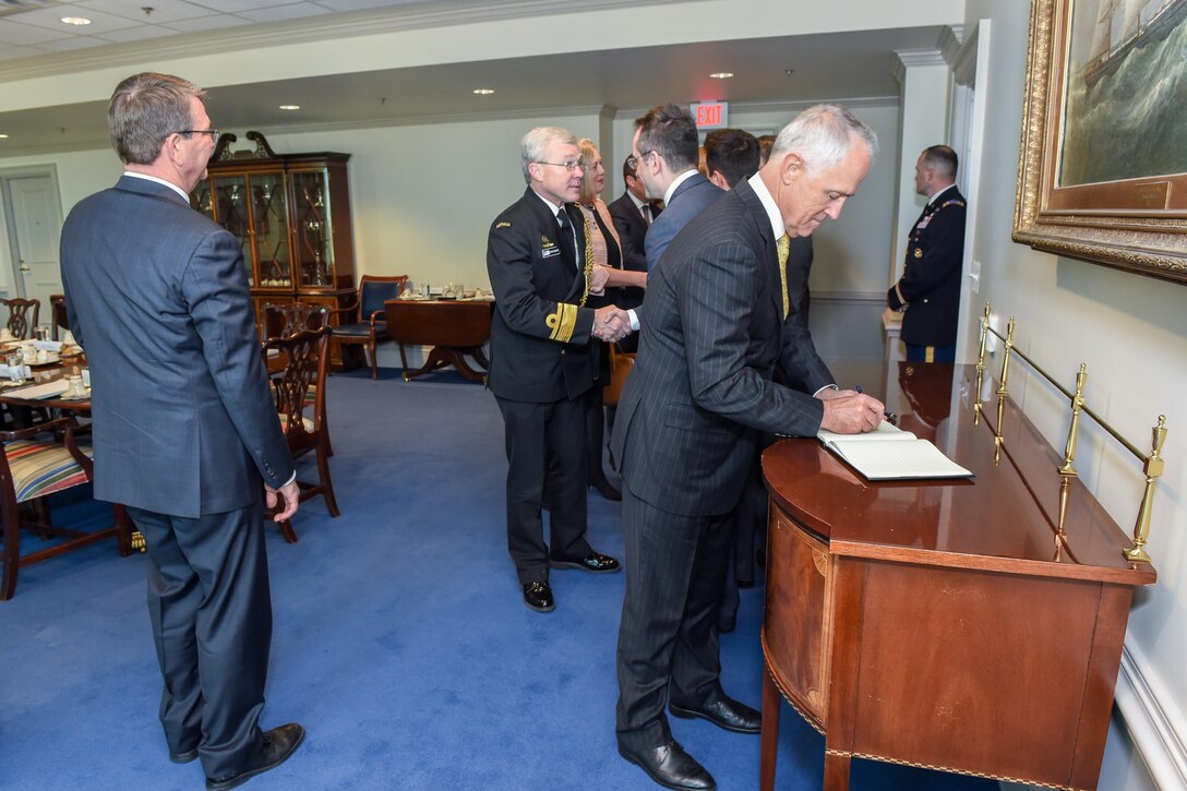 Australian Prime Minister Malcolm Turnbull signs the Pentagon's guest book as Defense Secretary Ash Carter looks on, Jan. 18, 2016. DoD photo by Army Sgt. First Class Clydell Kinchen