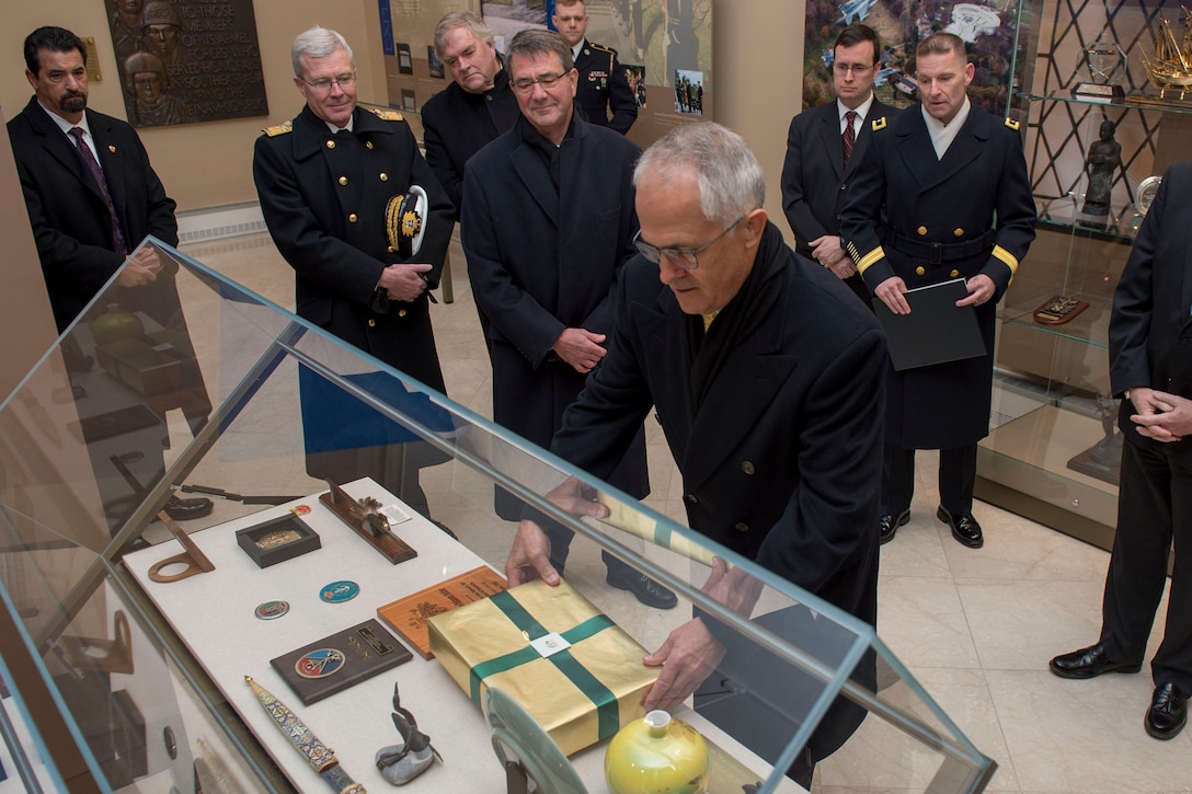 Australian Prime Minister Malcolm Turnbull leaves a gift after participating in a wreath-laying ceremony with Defense Secretary Ash Carter at the Tomb of the Unknown Soldier at Arlington National Cemetery, Arlington, Va., Jan. 18, 2016.  DoD photo by Senior Master Sgt. Adrian Cadiz