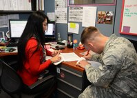 Senior Airman Jordan Williams, 36th Munitions Squadron munitions storage crew member, receives help from Lelani Dean, 36th Civil Engineer Squadron housing referral assistant, while filling out paperwork to get his overseas housing allowance started Jan. 13, 2016, at Andersen Air Force Base, Guam. OHA recently increased for junior enlisted service members, opening the door for more options when house hunting in the local community. (U.S. Air Force photo/Senior Airman Cierra Presentado)