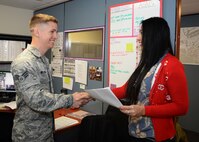Senior Airman Jordan Williams, 36th Munitions Squadron munitions storage member, thanks Lelani Dean, 36th Civil Engineer Squadron housing referral assistant, for assisting him through the overseas housing allowance process Jan. 2016, at Andersen Air Force Base, Guam. The housing office assists service members by advising them on the housing market, explaining how OHA works and starts the paperwork that begins OHA. (U.S. Air Force photo/Senior Airman Cierra Presentado)