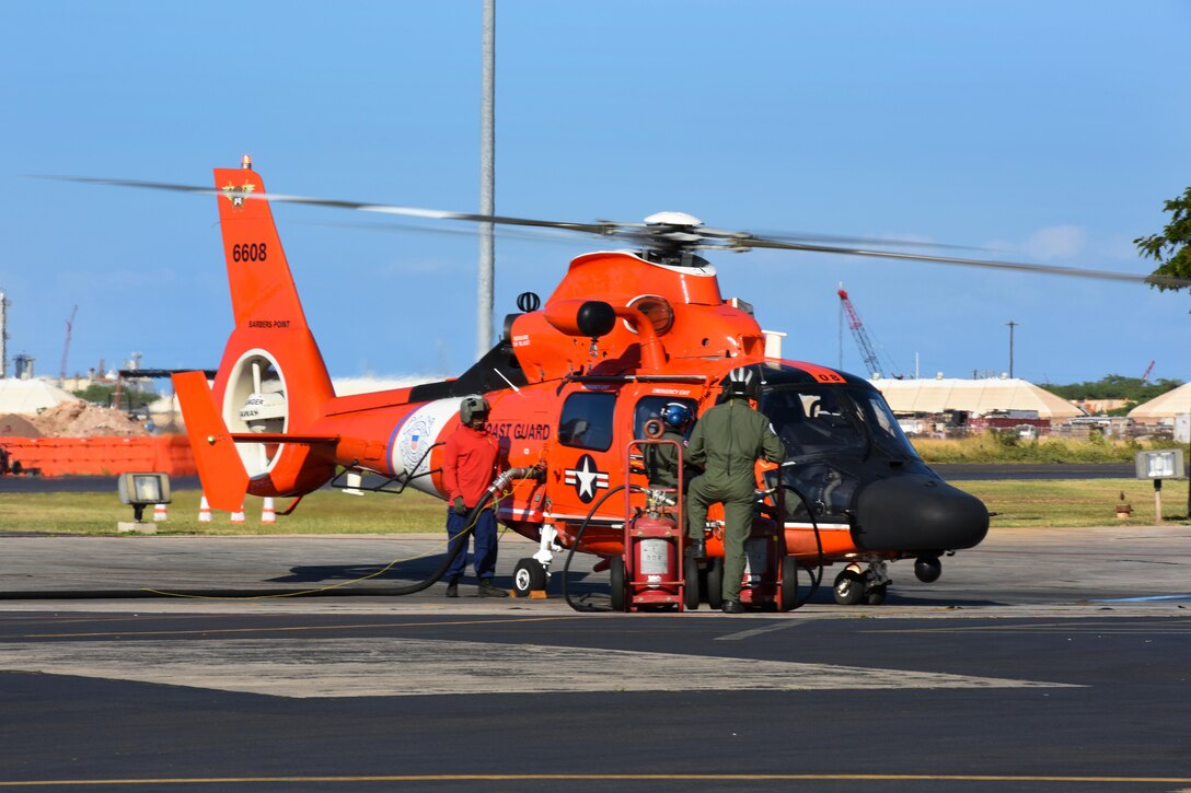 A Coast Guard MH-65 Dolphin helicopter crew refuels on Coast Guard Air Station Barbers Point in Kapolei, Hawaii, Jan. 17, 2016. The crew searched for survivors from the Jan. 14 incident involving Marine Corps CH-53E Super Stallion helicopters. U.S. Coast Guard photo by Petty Officer 3rd Class Joel Guzman