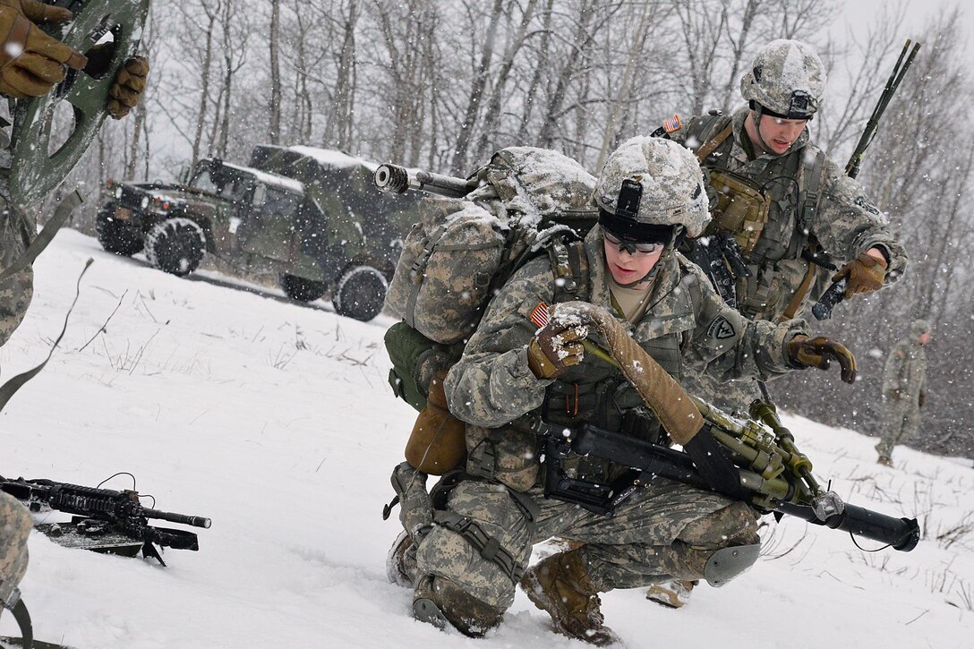 Army Staff Sgt. Ryan Fountain, back, and Army Spc. Thomas Snow, foreground, set up a 60 mm mortar before participating in a live-fire exercise on Joint Base Elmendorf-Richardson, Alaska, Jan. 12, 2016. Fountain and Snow are mortarmen assigned to Company C, 1st Battalion, 501st Infantry Regiment. U.S. Army photo by John Pennell