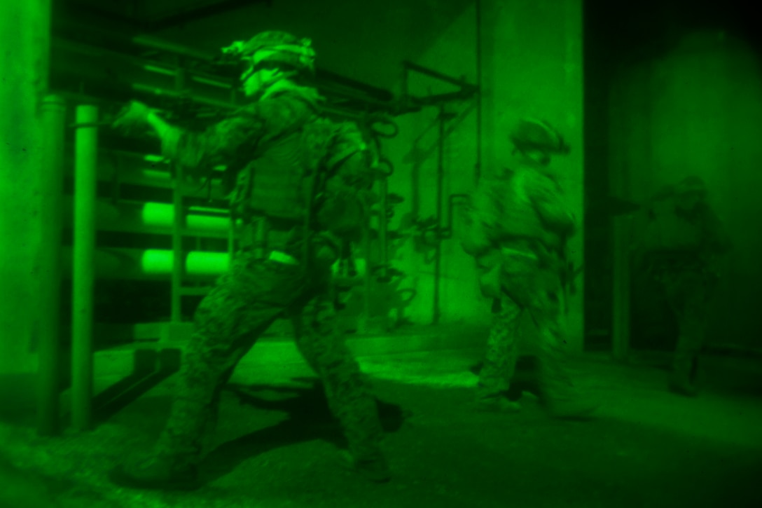 As seen through a night-vision device, a Marine provides security while his team moves toward its objective during an urban training exercise on Guam, Jan. 13, 2016. The Marines are assigned to Maritime Raid Force, 31st Marine Expeditionary Unit. U.S. Marine Corps Photo by Cpl. Thor J. Larson