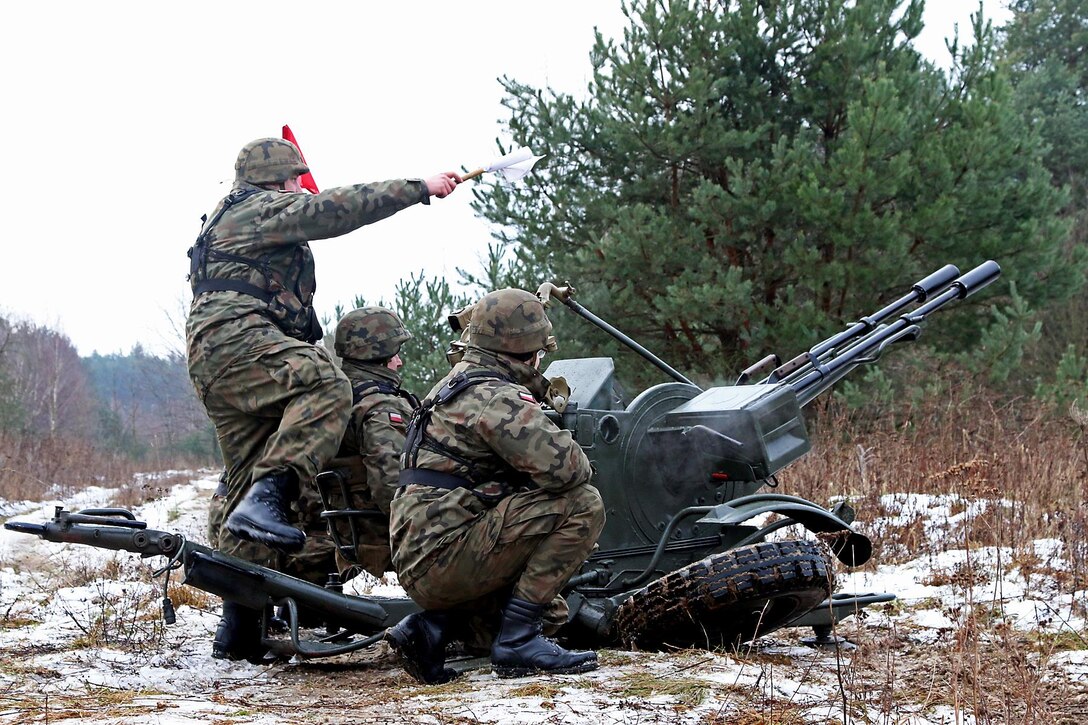 Polish soldiers simulate operating the 23mm anti-aircraft weapon system during a demonstration to U.S. soldiers in support of Patriot Shock, an interoperability deployment readiness exercise in Skwierzyna, Poland, Jan. 14, 2016. U.S. Army photo by Sgt. Paige Behringer