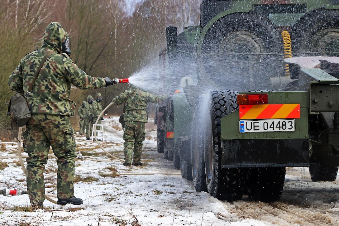 Polish soldiers demonstrate their vehicle decontamination capabilities to U.S. soldiers during Patriot Shock, an interoperability deployment readiness exercise in Skwierzyna, Poland, Jan. 14, 2016. U.S. Army photo by Sgt. Paige Behringer