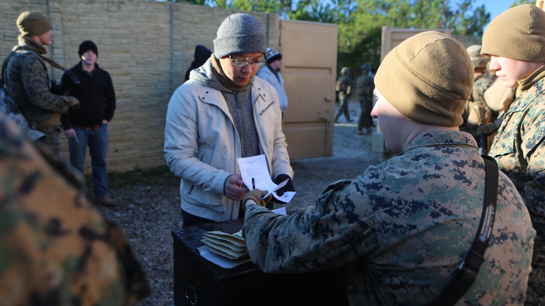 Lance Cpl. Jordan Martin, a rifleman with 2nd Battalion, 2nd Marine Regiment, evaluates and records a refugee role player’s identification paperwork during a noncombatant evacuation training operation  at Marine Corps Base Camp Lejeune, North Carolina, Jan. 14, 2016. The Marines successfully processed 28 refugee role players through a notional forward operating base. The exercise was part of the unit’s training in preparation for an upcoming deployment to Okinawa, Japan. 