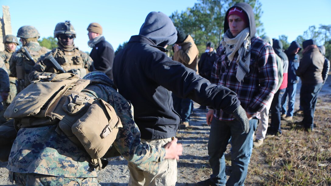 Marines with 2nd Battalion, 2nd Marine Regiment search refugee role players for any contraband that the refugees may be attempting to hide during a noncombatant evacuation training operation at Marine Corps Base Camp Lejeune, North Carolina, Jan. 14, 2016. The Marines successfully processed 28 refugee role players through a notional forward operating base. The exercise was part of the unit’s training in preparation for an upcoming deployment to Okinawa, Japan. 