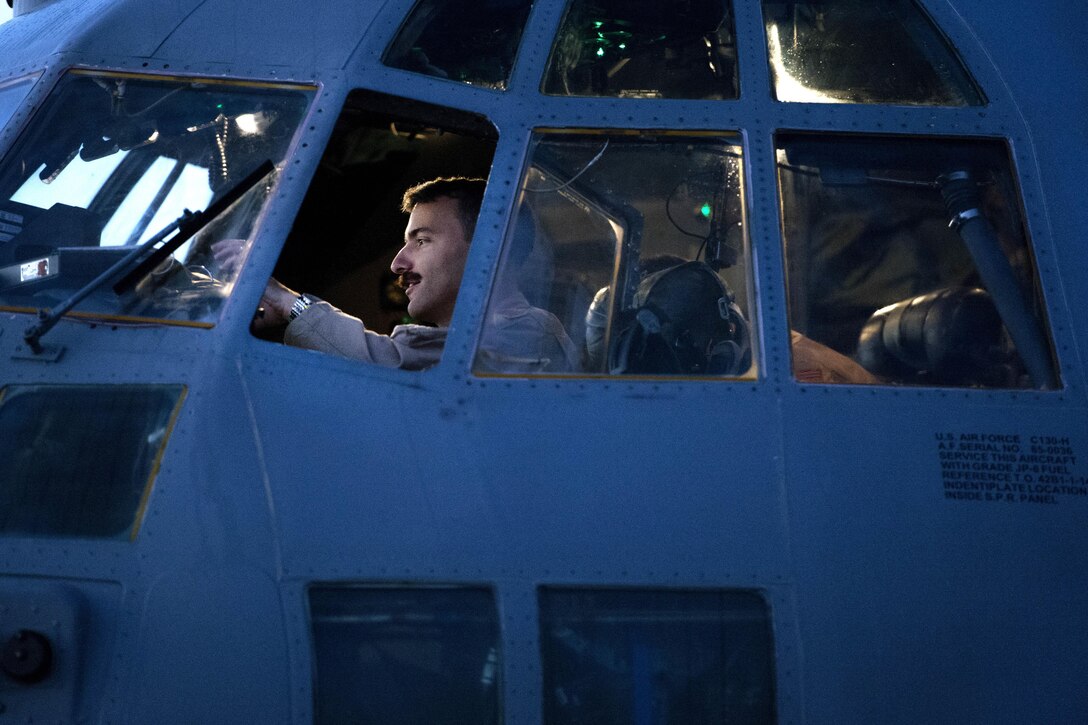 U.S. Air Force Capt. Steven Marinos performs preflight checks inside a C-130H Hercules aircraft on Al Udeid Air Base, Qatar, Jan. 6, 2016. Marinos is a pilot assigned to the 746th Expeditionary Airlift Squadron. U.S. Air Force photo by Tech. Sgt. Nathan Lipscomb