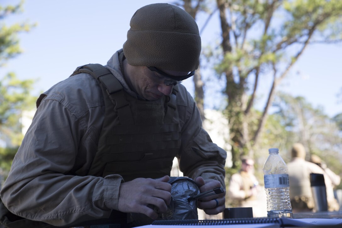 Sgt. Kyle Kazmierczak, an Explosive Ordinance Disposal technician with EOD Company, 8th Engineer Support Battalion, wraps tape around an explosive charge during a breaching course at Camp Lejeune, N.C., Jan.14, 2016. The course is designed to reinforce proper breaching techniques EOD technicians must retain for upcoming deployments. (U.S. Marine Corps photo by Lance Cpl. Samuel Guerra/Released)
