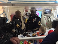 Master Sgt. Troy Roberson and Sgt. 1st Class Joseph Bush from the 11th Theater Aviation Command (TAC), volunteered their time to distribute toys to hospitalized children at Kosair Children’s Hospital in Louisville, Ky., Jan. 9. The toys were donated by soldiers, family members and friend of the 11th TAC. The 11th TAC is the only aviation command in the U.S. Army Reserve. (U.S. Army photo by Capt. Matthew Roman, 11th Theater Aviation Command Public Affairs Officer)