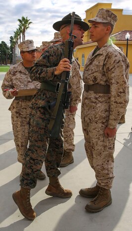 Staff Sgt. Keith A. Porter, drill instructor, Fox Company, 2nd Recruit Training Battalion, inspects a recruit’s M16-A4 Service Rifle during a series commander inspection at Marine Corps Recruit Depot San Diego, Dec. 28. Drill instructors inspect for carbon that builds up on the recruits’ rifles over time. Recruits are given a significant amount of time to clean their rifles every day to ensure proper working order. Annually, more than 17,000 males recruited from the Western Recruiting Region are trained at MCRD San Diego. Fox Company is scheduled to graduate Jan. 29.