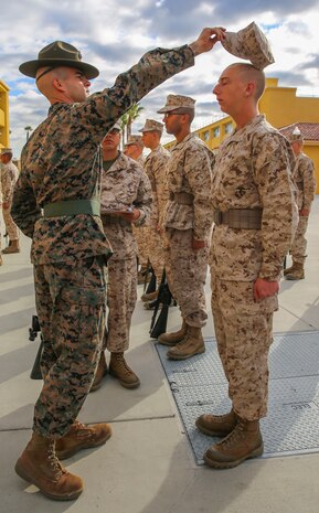 Staff Sgt. Keith A. Porter, drill instructor, Fox Company, 2nd Recruit Training Battalion, checks to see if a recruit’s cover is properly labeled during a series commander inspection at Marine Corps Recruit Depot San Diego, Dec. 28. Recruits are taught to label their items and uniforms to be able to keep track of them more easily. Prior to the event, drill instructors spend time preparing their recruits to pass the inspection by telling them what to expect. Annually, more than 17,000 males recruited from the Western Recruiting Region are trained at MCRD San Diego. Fox Company is scheduled to graduate Jan. 29.