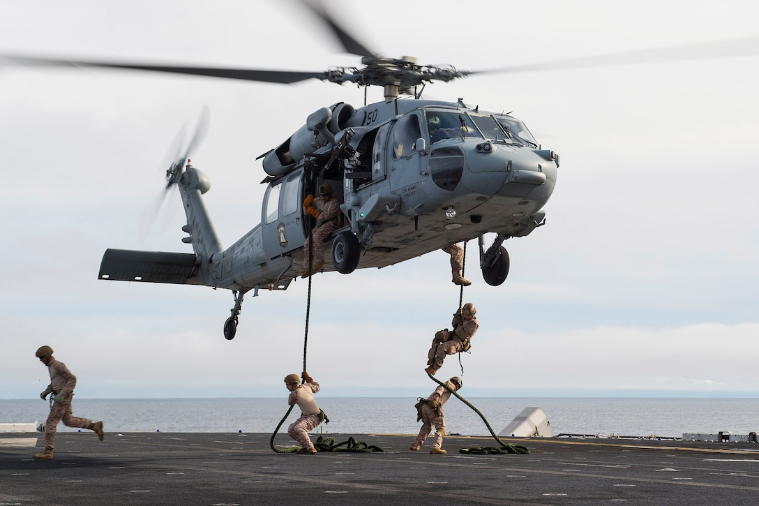 U.S. Marines conduct fast rope drills on the flight deck of the amphibious assault ship USS Boxer in the Pacific Ocean, Jan. 18, 2016. The Boxer is currently preparation for an upcoming deployment. The Marines are assigned to 13th Marine Expeditionary Unit.  U. S. Navy photo by Petty Officer 2nd Class Debra Daco