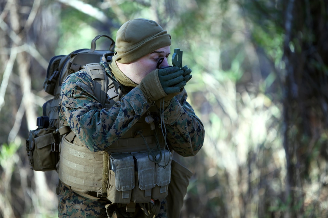 Lance Cpl. Joshua B. Gilmore sets his azimuth to the next point during a land navigation course at Marine Corps Air Station Cherry Point, N.C., Jan. 13, 2016. During the 19-point course, 20 Marines with Marine Wing Support Squadron 274’s Engineer Company, Heavy Equipment Platoon headed to the field to re-experience the basic land navigation process. The course was a refresher for most of the Marines, who have not used land navigation since Marine Combat Training. Gilmore is an engineer equipment operator with MWSS-274. (U.S. Marine Corps photo by Pfc. Nicholas P. Baird/Released)