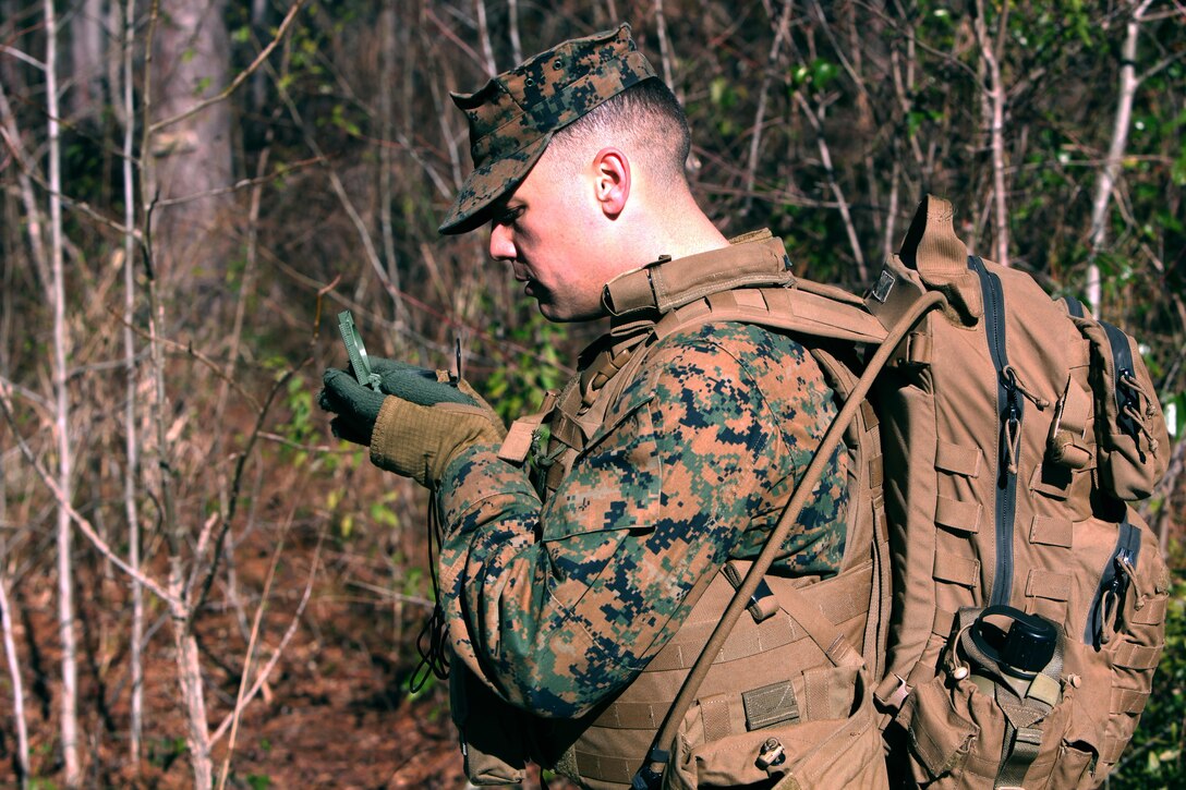 Lance Cpl. Joshua B. Gilmore sets his azimuth to the next point during a land navigation course at Marine Corps Air Station Cherry Point, N.C., Jan. 13, 2016. During the 19-point course, 20 Marines with Marine Wing Support Squadron 274’s Engineer Company, Heavy Equipment Platoon headed to the field to re-experience the basic land navigation process. The course was a refresher for most of the Marines, who have not used land navigation since Marine Combat Training. Gilmore is an engineer equipment operator with MWSS-274. (U.S. Marine Corps photo by Pfc. Nicholas P. Baird/Released)