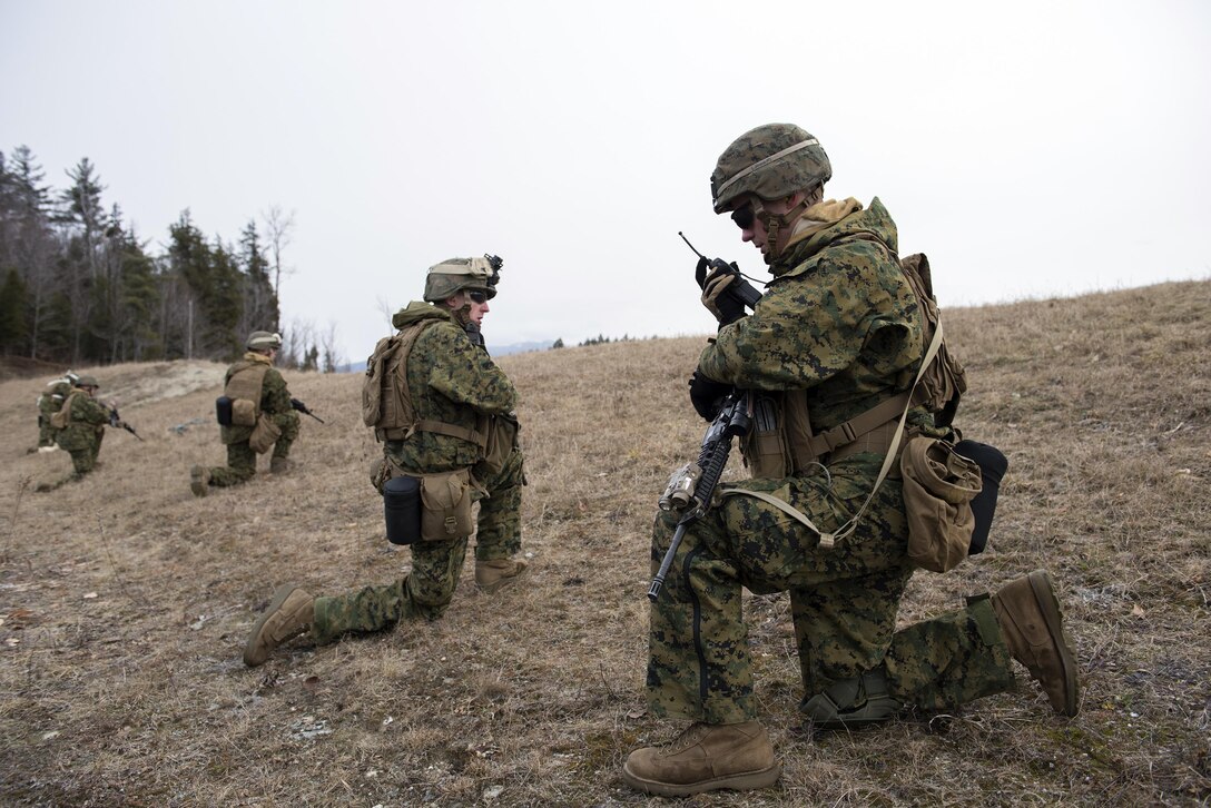 A Marine talks on his radio with team leaders during a patrol break as on Camp Ethan Allen Training Site, Jericho, Vt., Jan. 12, 2016. Vermont Air National Guard photo by Tech. Sgt. Sarah Mattison