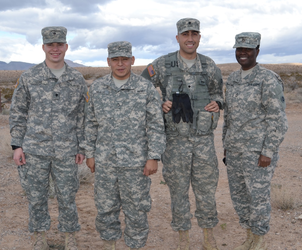 Spc. Matthew Litke, Pfc. Antonio Araujo, Spc. David Montes and Master Sgt. Melinda Barnes, 314th Combat Sustainment Battalion logistics and Best Warrior Competition noncommissioned officer in charge, before they compete on the land navigation course at Nellis Air Force Base Jan. 9.