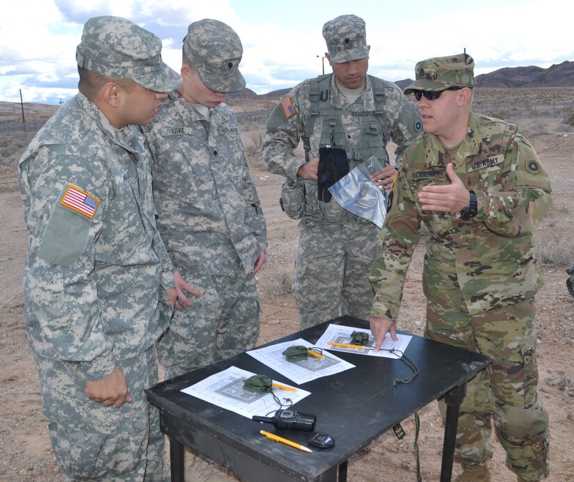 Staff Sgt. Matthew Schneider, Best Warrior Competition land navigation noncommissioned officer in charge, instructs competitors on the land navigation course, during a competition held by the 314th Combat Sustainment Battalion and was held at its headquarters and Nellis Air Force Base Jan. 9.