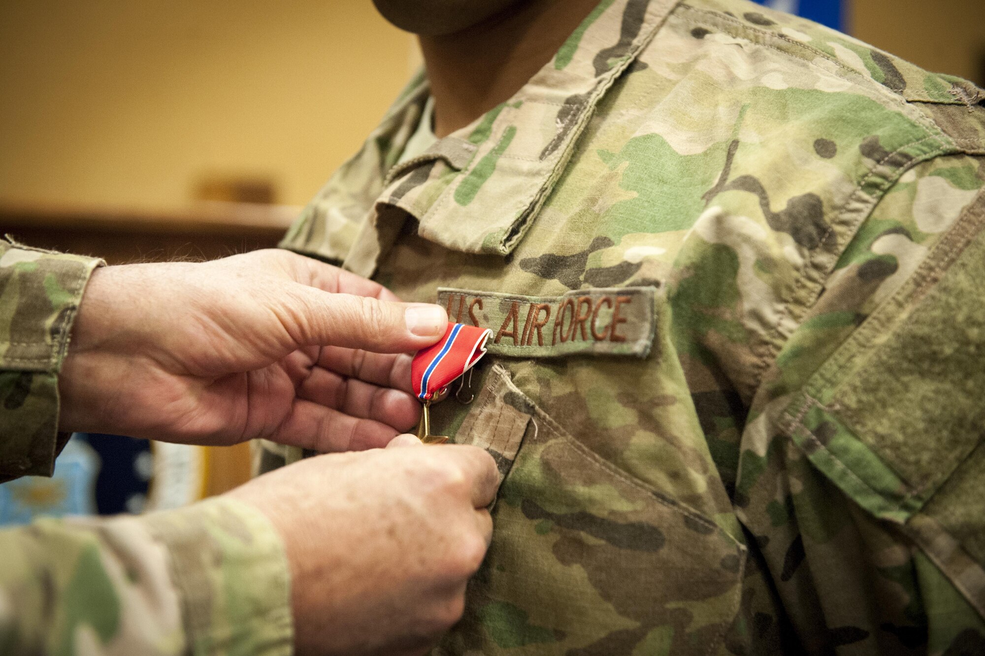 Lt. Gen. Bradley Heithold, Commander Air Force Special Operations Command, pins a Bronze Star on Capt. Jophiel Philips, 27th Special Operations Wing Judge Advocate, during a medal presentation ceremony Jan. 12, 2016, at Cannon Air Force Base, N.M. Philips assisted in the defending Camp Integrity, Afghanistan during an insurgent attack in 2015. (U.S. Air Force photo/Tech. Sgt. Manuel Martinez)