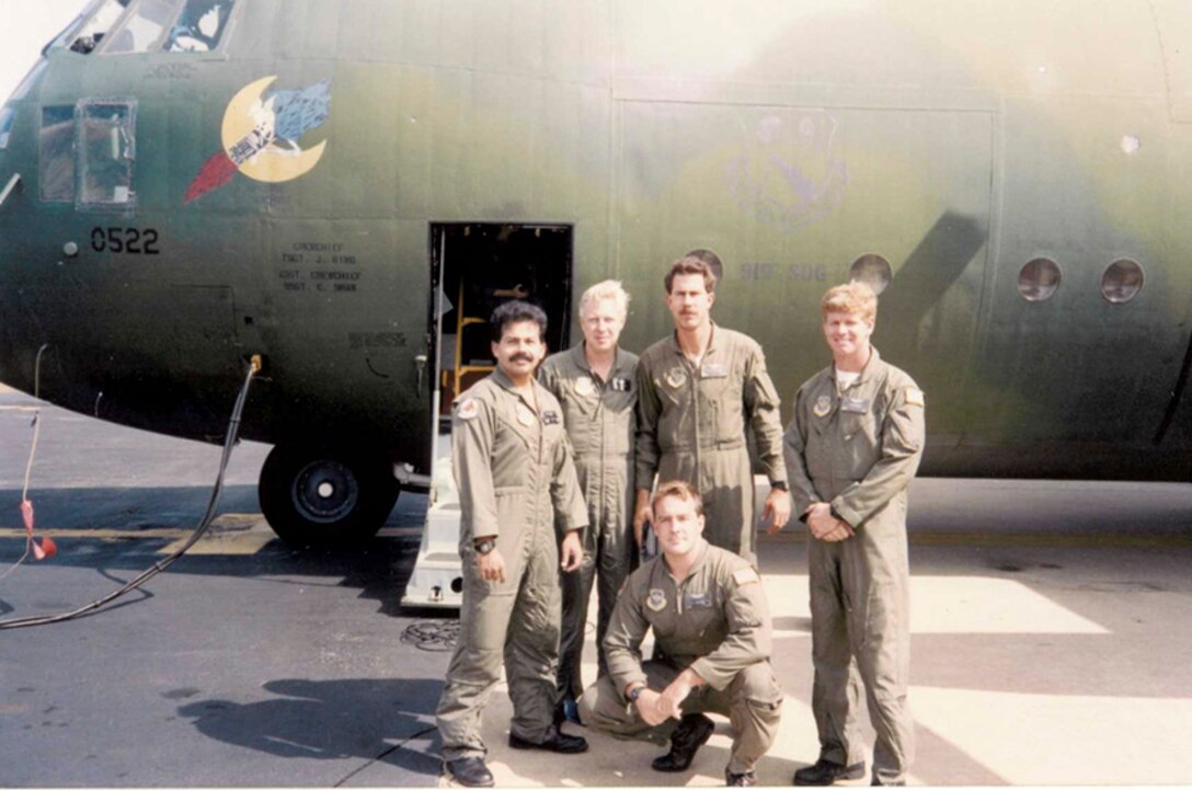 Crew members from the 701st Airlift Squadron pose for a picture in front of a C-141B during Operation Desert Storm.