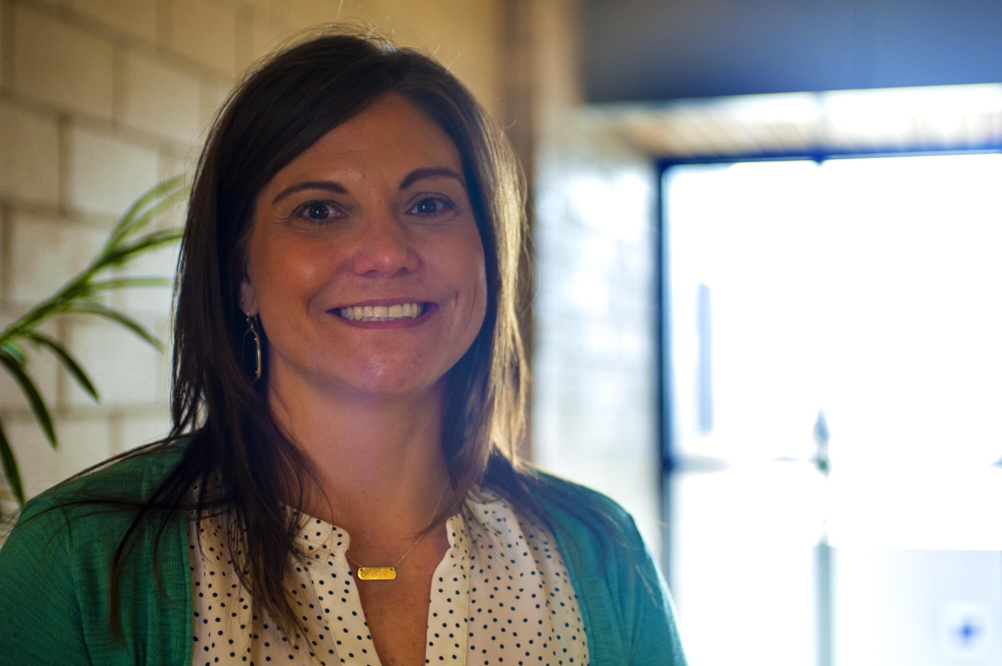 Theresa Goodwin, 17th Training Wing school liaison officer, poses for a portrait in the Norma Brown building at Goodfellow Air Force Base, Texas, Jan. 19, 2016. SLOs specialize in educational programs within the local area, assisting military members with meeting their needs for their children’s education. (U.S. Air Force photo by Senior Airman Scott Jackson/released)