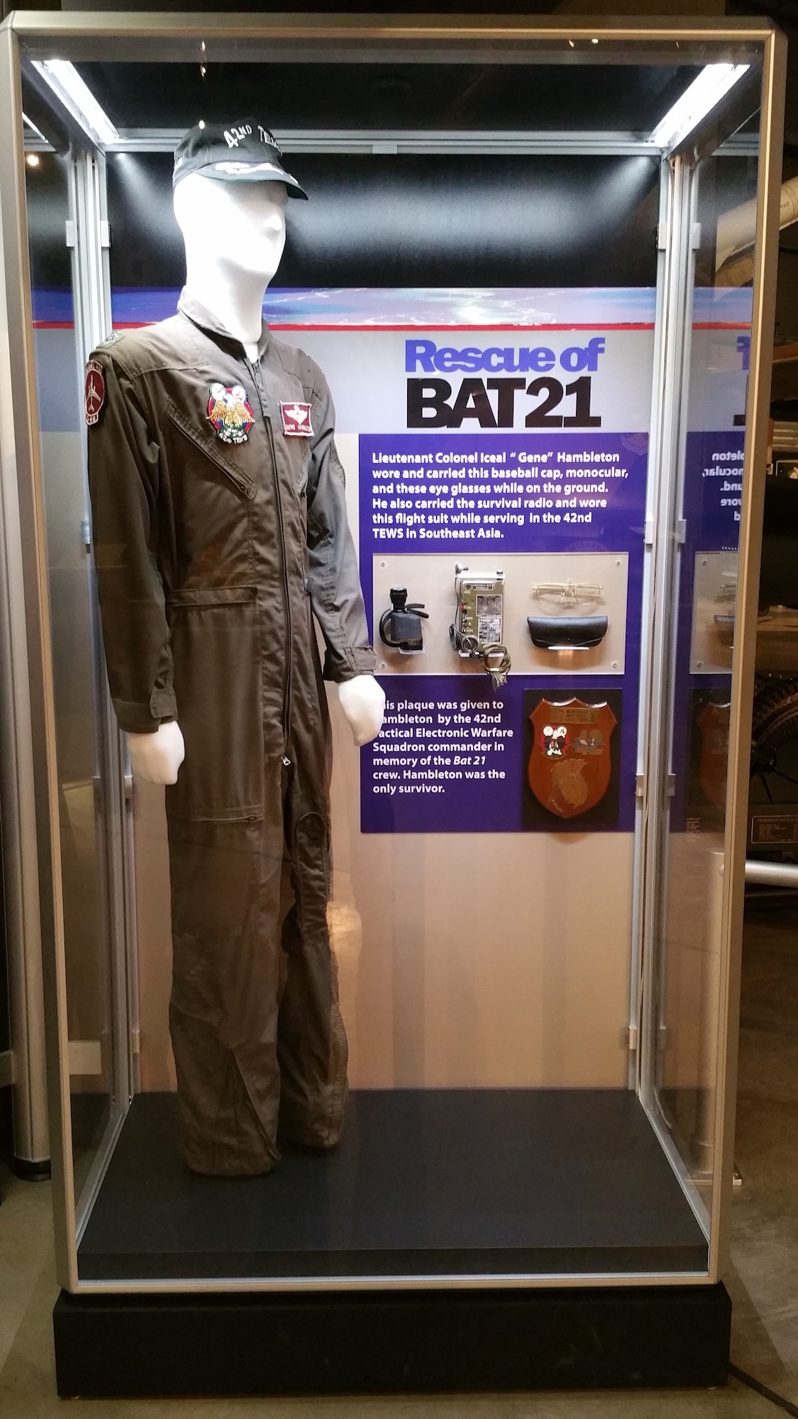 Displayed on this mannequin are the baseball cap, monocular and glasses that Lt. Col. Iceal "Gene" Hambleton had with him when rescued. He also carried the survival radio and wore this flight suit while serving in the 42nd TEWS in Southeast Asia. (U.S. Air Force photo)

