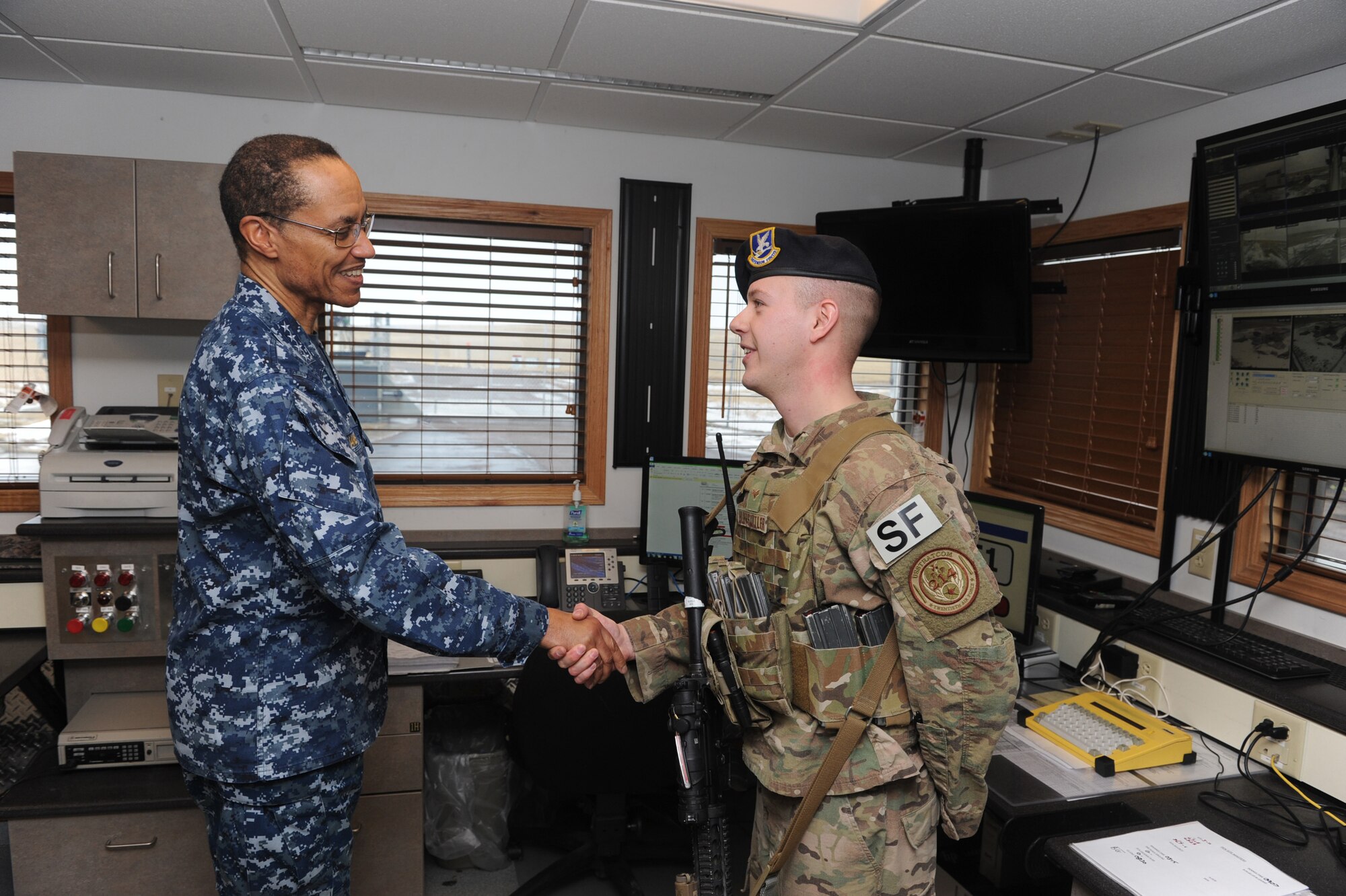 U.S. Navy Adm. Cecil D. Haney (left), U.S. Strategic Command (USSTRATCOM) commander, presents a commanders coin to Senior Airman Michael Huffstutler, 341st Missile Security Forces Squadron flight security controller, during Haney’s visit to a missile alert facility Jan. 14, 2016, near Malmstrom Air Force Base, Mont. During his visit to Malmstrom AFB, Haney had breakfast with Airmen; toured the security forces, missile maintenance and other facilities; and conducted a base-wide all call to discuss USSTRATCOM’s mission areas and priorities and Malmstrom’s vital role in deterrence and assurance. He also thanked the men and women at Malmstrom for their efforts in providing the nation with a safe, secure, effective and ready nuclear deterrent. One of nine DoD unified combatant commands, USSTRATCOM has global strategic missions, assigned through the Unified Command Plan, which include strategic deterrence; space operations; cyberspace operations; joint electronic warfare; global strike; missile defense; intelligence, surveillance and reconnaissance; combating weapons of mass destruction; and analysis and targeting. (U.S. Air Force photo by Airman Daniel Brosam)