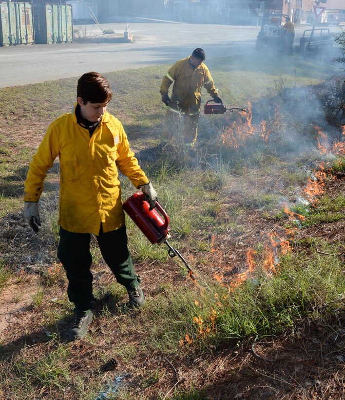 Julie Robbins (front), natural resources manager, and Sgt. Greg Rieder, both with Environmental Branch, Installation and Environment Division, Marine Corps Logistics Base Albany, conducts the installation’s annual prescribed burning of base timber, Jan 11.