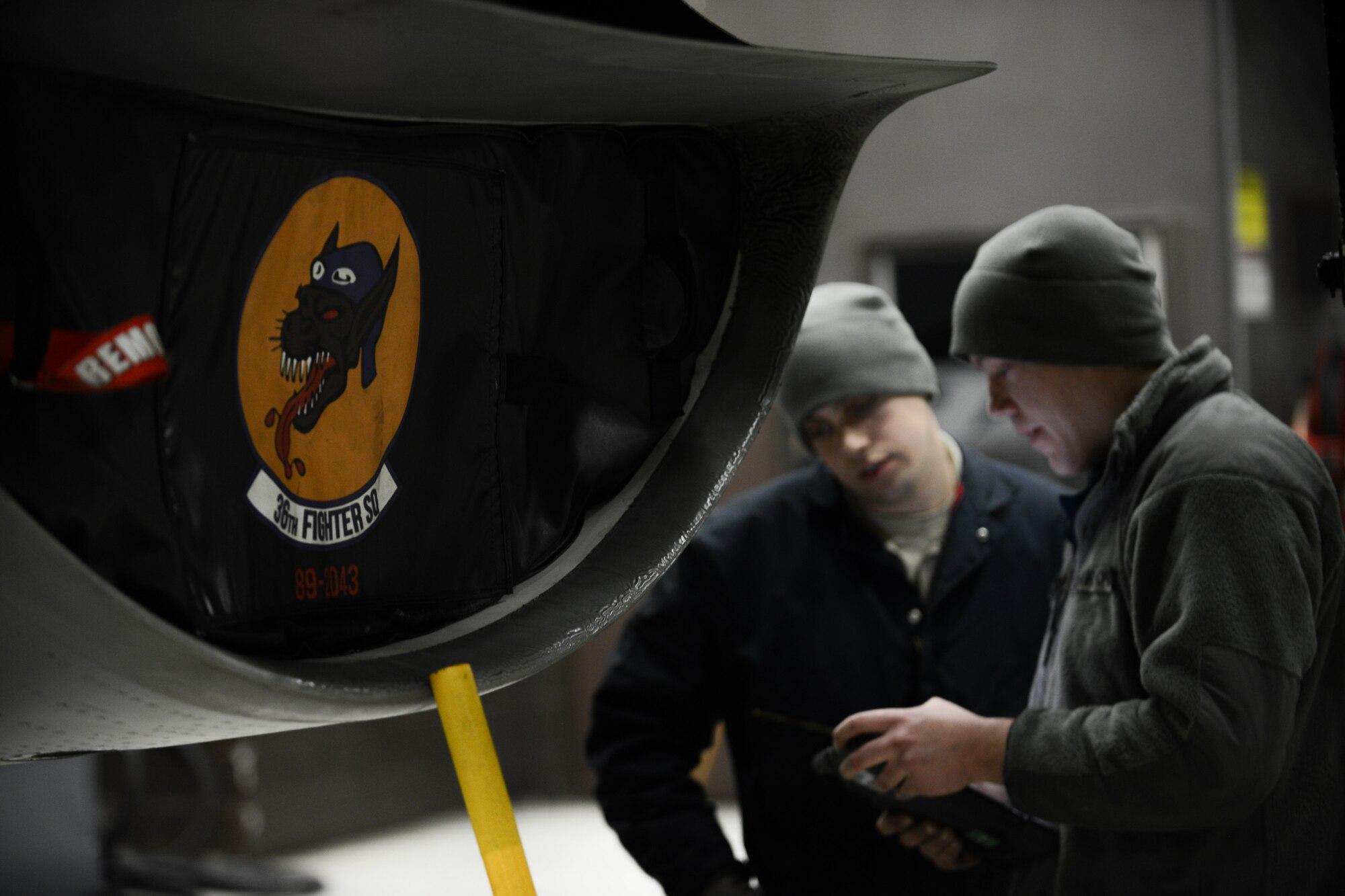 Crew chiefs from the 36th Aircraft Maintenance Unit review technical orders during routine maintenance at Osan Air Base, Republic of Korea, Jan. 12, 2016. The 36th AMU prepare, refuel and inspect each of Osan’s F-16s to ensure fight tonight readiness of the 36th Flying Squadron. (U.S. Air Force photo by Airman 1st Class Dillian Bamman/Released)