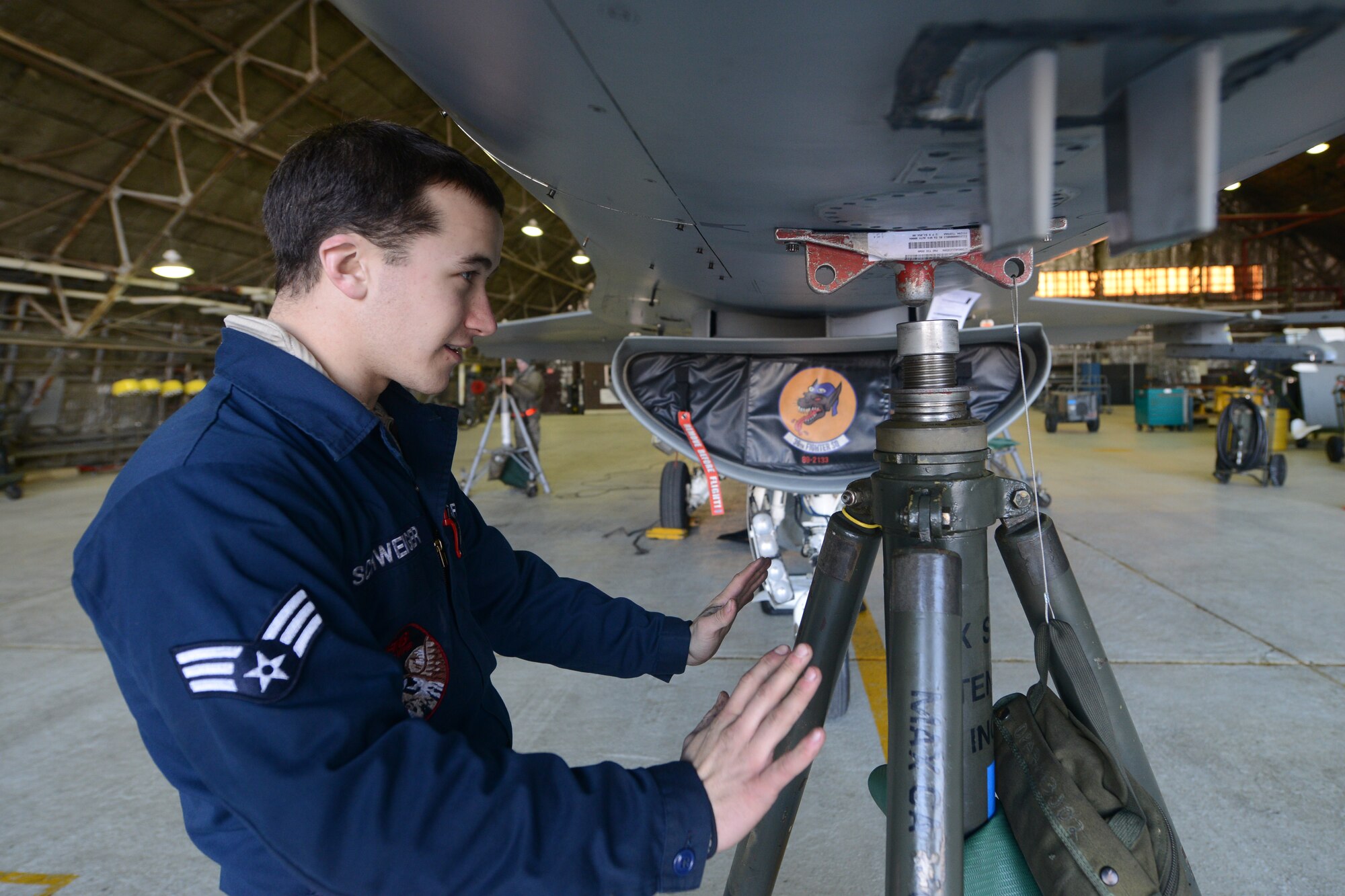 Senior Airman Kevin Schweiger, 36th Aircraft Maintenance Unit crew chief, grounds an F-16 Fighting Falcon during routine maintenance at Osan Air Base, Republic of Korea, Jan. 12, 2016. Schweiger said the most rewarding aspect of his career is the responsibility of maintaining a 60-million dollar aircraft that provides safety to an entire country. (U.S. Air Force photo by Airman 1st Class Dillian Bamman/Released)