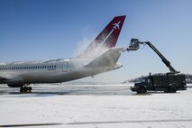 An Airman from the 51st Maintenance Squadron uses an aircraft de-icer on the Patriot Express passenger aircraft after a large amount of snowfall at Osan Air Base, Republic of Korea, Jan. 14, 2016. The de-icing process ensures the safe travel of passengers and cargo. (U.S. Air Force photo by Airman 1st Class Dillian Bamman/Released)