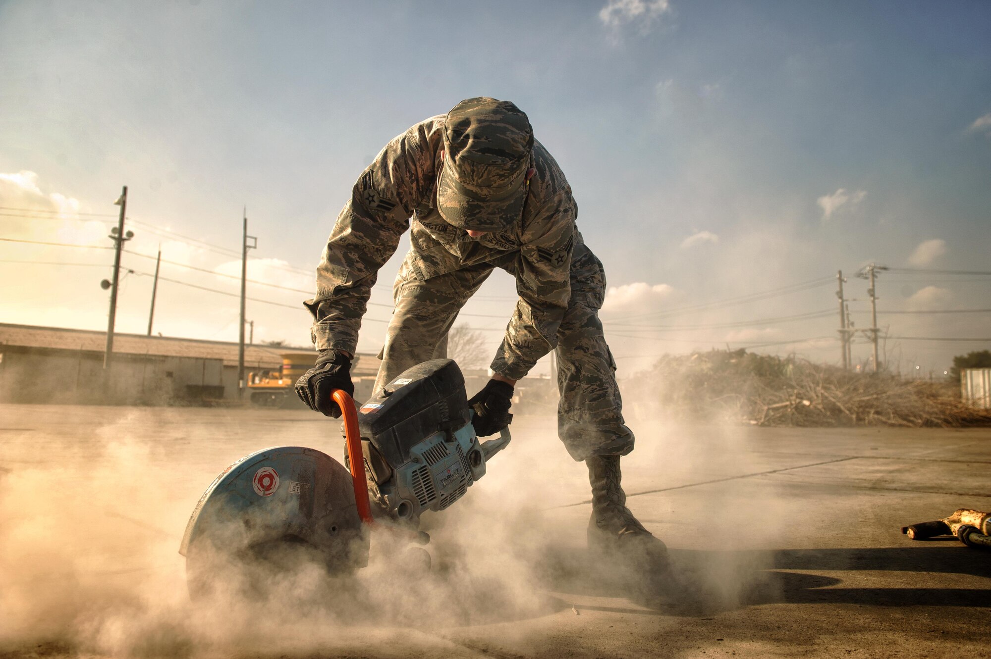 Airman 1st Class Connor Harrington, 374th Civil Engineer Squadron pavement and equipment apprentice, performs a spall repair at Yokota Air Base, Japan, Jan. 13, 2016. From keeping the flightline mission ready to maintaining the roads and sidewalks, the behind the scenes work done by the group of Airmen known as the 'Dirt Boys' keep Yokota's mission going. (U.S. Air Force photo by Airman 1st Class Delano Scott/Released)