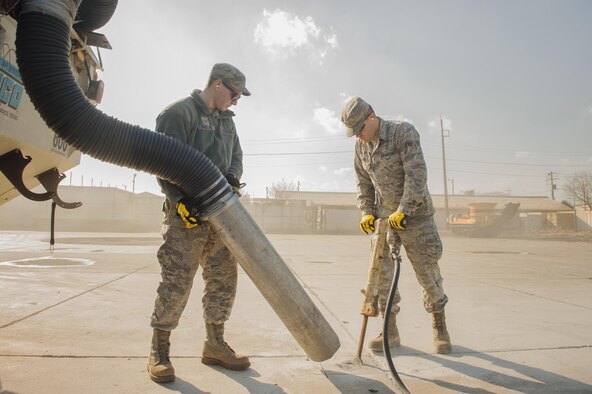 Airmen 1st Class Jacob Fetters and Brendan Kinser, both 374th Civil Engineer Squadron pavement and equipment technicians, perform a spot repair on a section of Yokota Air Base, Japan, Jan. 13, 2016. From shovels and jackhammers to cranes and bulldozers, the duties of the “Dirt Boys” require them to be experts of a wide assortment of machinery. (U.S. Air Force photo/Airman 1st Class Delano Scott)