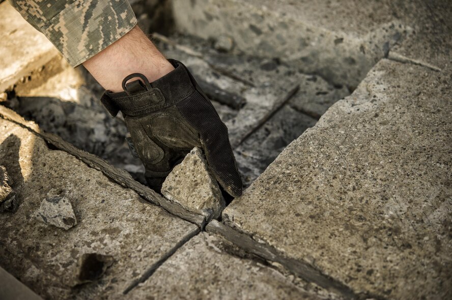 Airman 1st Class Connor Harrington, 374th Civil Engineer Squadron pavement and equipment apprentice, removes a section of concrete from a spall repair site on Yokota Air Base, Japan, Jan. 13, 2016. Aptly named ‘Dirt Boys’, 374th CES pavement and equipment Airmen perform spall repairs as part of their preventative maintenance practices to ensure Yokota’s airfield is free of cracks and tears. (U.S. Air Force photo by Airman 1st Class Delano Scott/Released)