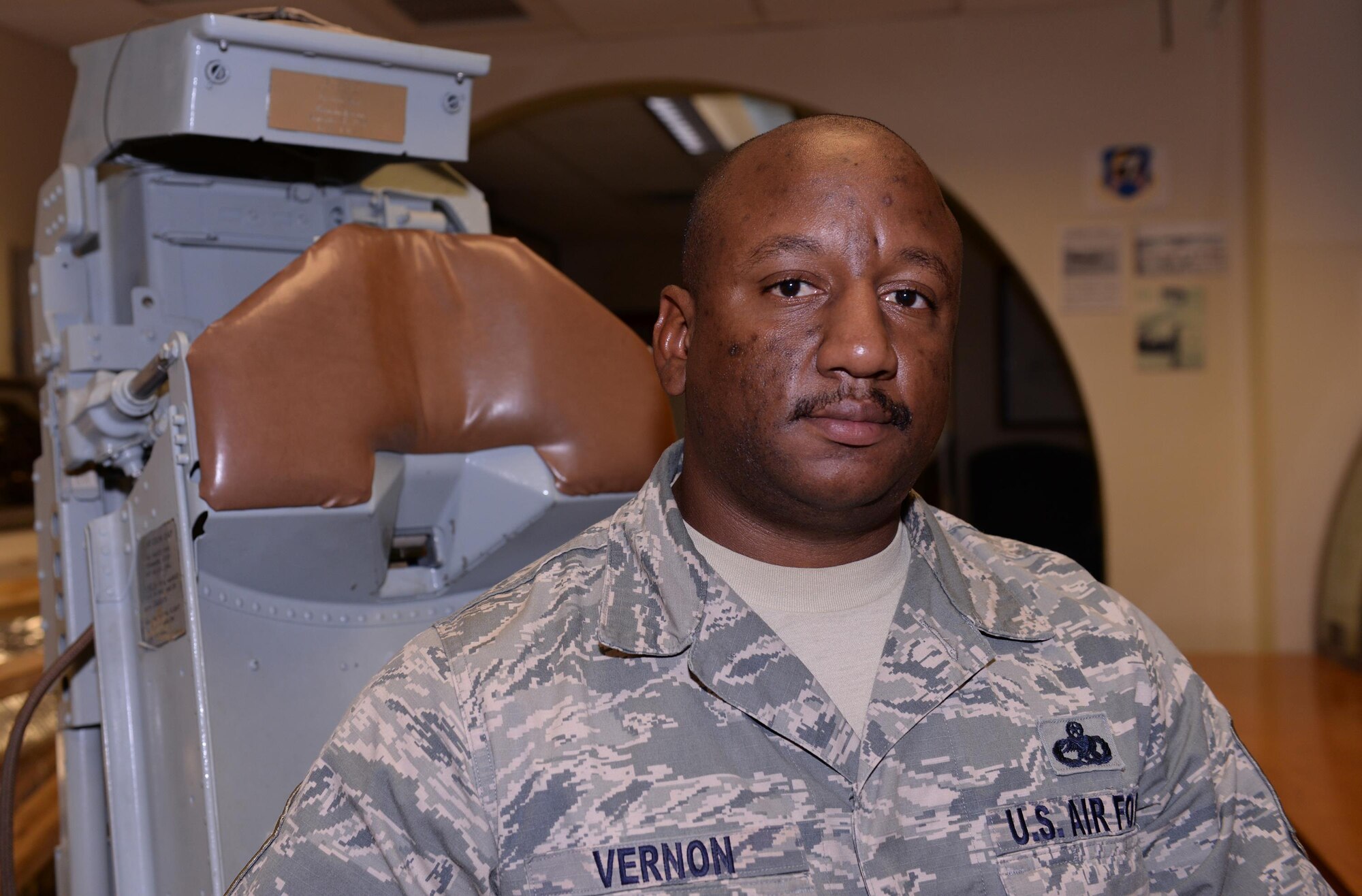 Master Sgt. Rorique Vernon, 36th Maintenance Squadron accessories flight chief, sits in a restored B-52D Stratofortress pilot’s seat Jan. 7, 2016, at the heritage hall museum on Andersen Air Force Base, Guam. Vernon holds a volunteer position as the Wing historical property custodian and manages the museums inventory of artifacts. (U.S. Air Force photo/Airman 1st Class Jacob Skovo)