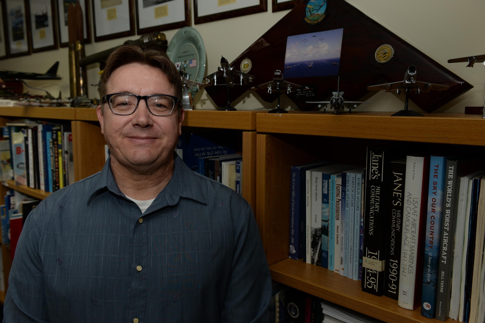 Jeffrey Meyer, 36th Wing historian, stands next to a collection of fighter plane models Jan. 8, 2016, at Andersen Air Force Base, Guam. As the historian, Meyer documents Andersen’s current history and oversees the museum.  (U.S. Air Force photo/Airman 1st Class Jacob Skovo)