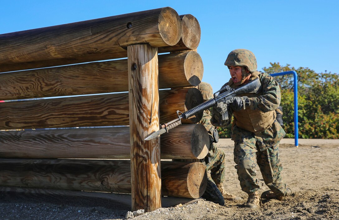 A recruit of Charlie Company, 1st Recruit Training Battalion, rushes from behind an obstacle during the Bayonet Assault Course at Marine Corps Recruit Depot San Diego, Dec. 29. Recruits were instructed to move quickly during the course to simulate maneuvering around dangerous environments during combat situations. Annually, more than 17,000 males recruited from the Western Recruiting Region are trained at MCRD San Diego. Charlie Company is scheduled to graduate Jan. 22.