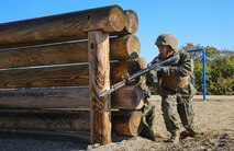 A recruit of Charlie Company, 1st Recruit Training Battalion, rushes from behind an obstacle during the Bayonet Assault Course at Marine Corps Recruit Depot San Diego, Dec. 29. Recruits were instructed to move quickly during the course to simulate maneuvering around dangerous environments during combat situations. Annually, more than 17,000 males recruited from the Western Recruiting Region are trained at MCRD San Diego. Charlie Company is scheduled to graduate Jan. 22.