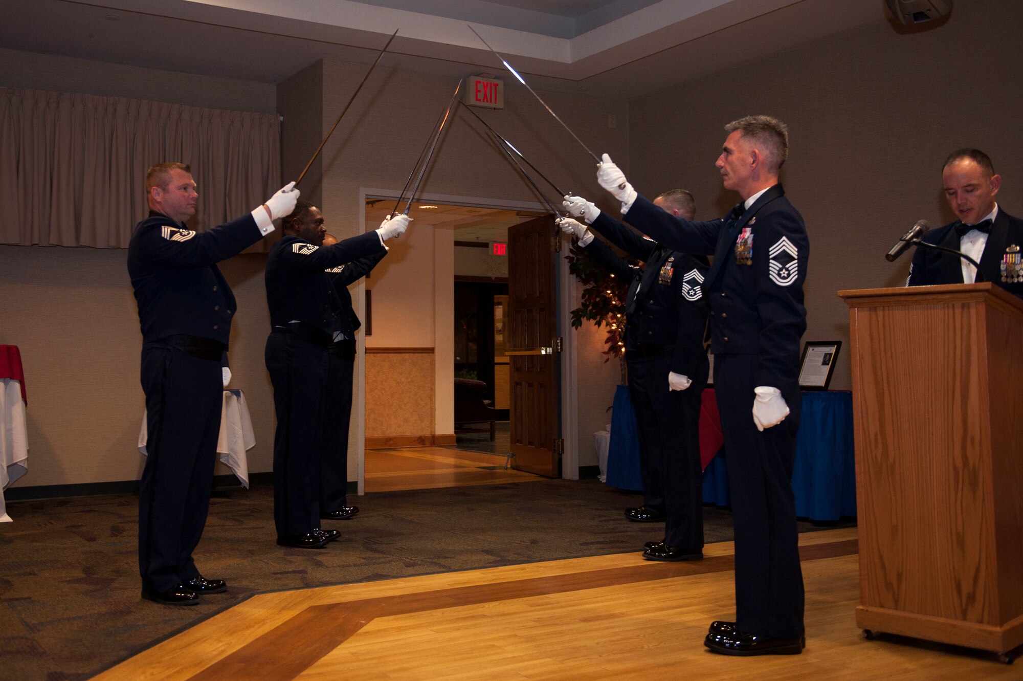 A saber detail raises their swords during the Chief Recognition Ceremony, Jan. 16, 2016, at Moody Air Force Base, Ga. Each chief select was brought in separately to be recognized for their accomplishment of being promoted to the rank of chief master sergeant. (U.S. Air Force photo by Airman 1st Class Kathleen D. Bryant/Released)
