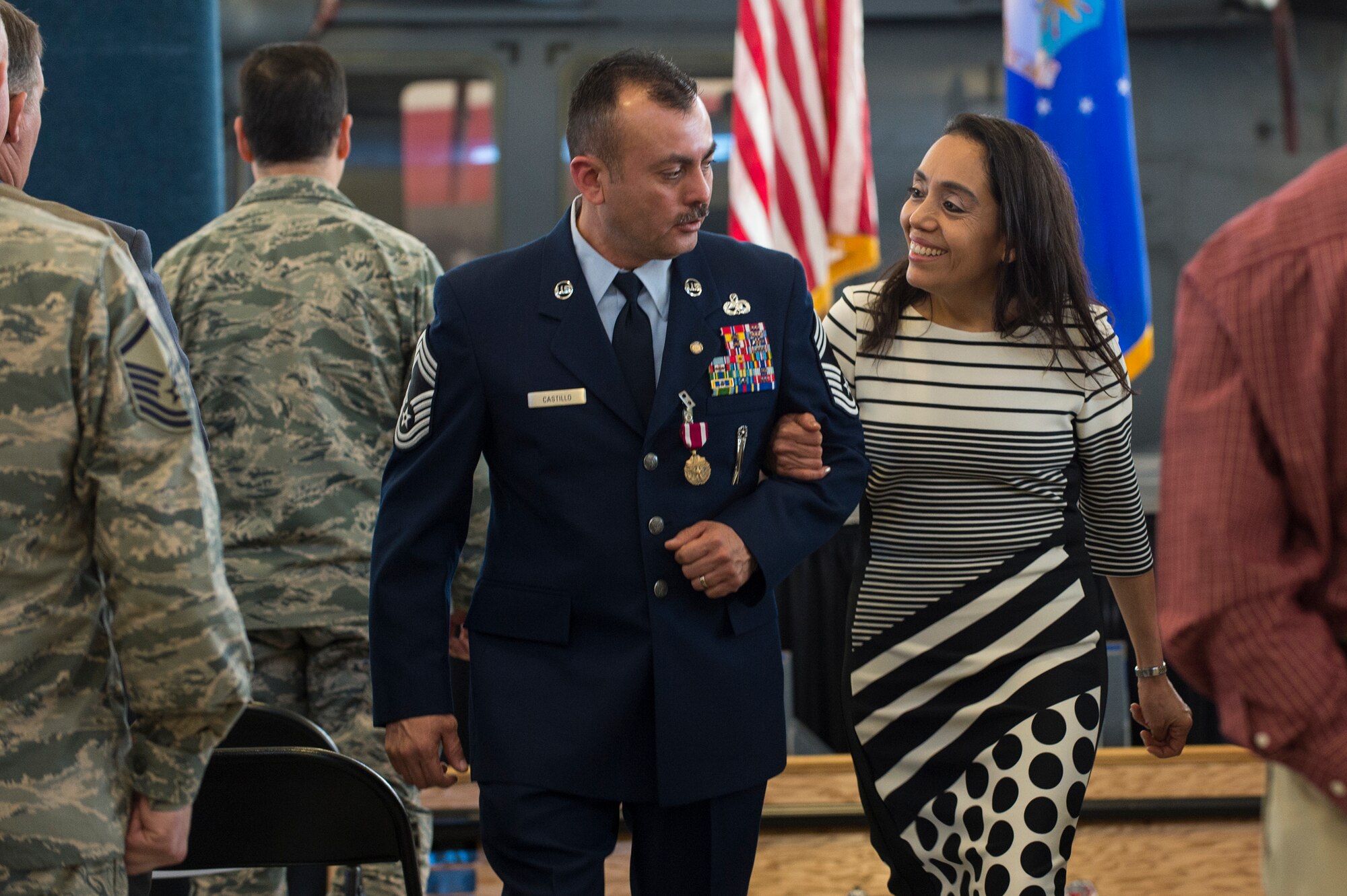 U.S. Air Force Chief Master Sgt. Guillermo Castillo, 23d Maintenance Group wing weapons manager, and his wife Beatriz exit Castillo’s retirement ceremony,  Jan. 15, 2016, at Moody Air Force Base, Ga. Castillo says goodbye to the various leadership positions he held through his career including wing weapons manager, superintendent and section chief.(U.S. Air Force photo by Senior Airman Ceaira Tinsley/Released)
