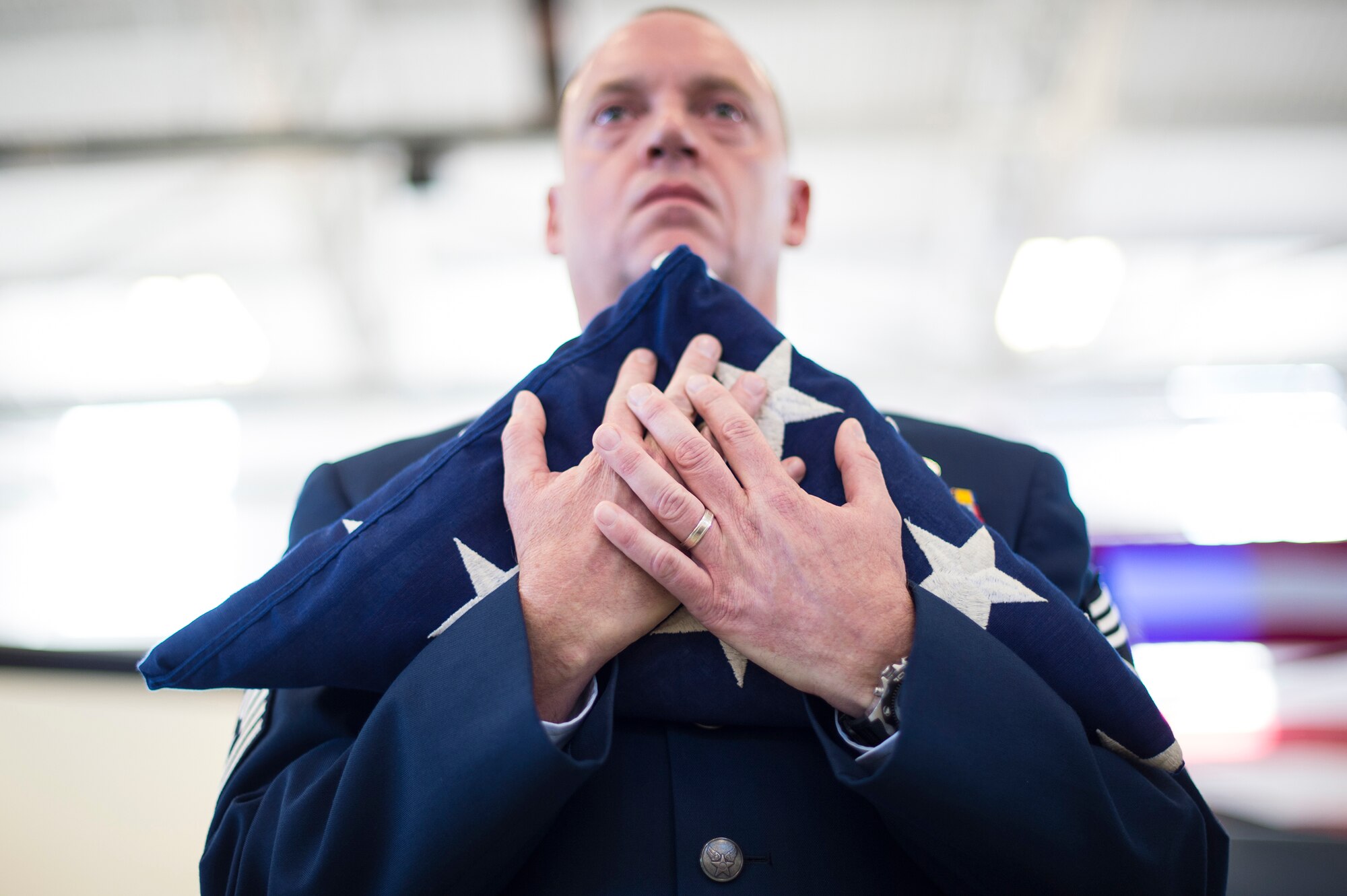 U.S. Air Force Chief Master Sgt. Todd Folks, 96th Maintenance Group wing weapons manager, hold a flag during Chief Master Sgt. Guillermo Castillo’s retirement, Jan. 15, 2016, at Moody Air Force Base, Ga. Folks represented the rank of chief master sergeant which is the highest rank Castillo achieved. (U.S. Air Force photo by Senior Airman Ceaira Tinsley/Released)