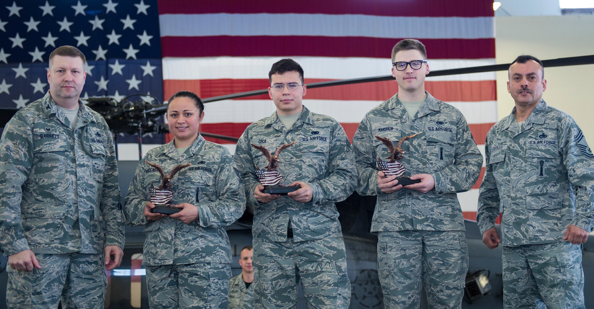 U.S. Air Force Col. Shane Barrett, 23d Maintenance Group commander, far left, and Chief Master Sgt. Guillermo Castillo, 23d Wing weapons manager, far right, pose with members of the 74th Aircraft Maintenance Unit weapons load team, winners of the quarterly weapons load competition, Jan. 15, 2015, at Moody Air Force Base, Ga. Even though the 75th AMU finished in an earlier time, the 74th’s proficiency and strategy allowed them to minimize infractions to take home the bragging rights. (U.S. Air Force photo by Airman 1st Class Greg Nash/Released)   